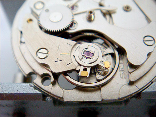 Seiko 7S26 balance bridge><p>

It is <u>absolutely crucial</u> that regulating levers are not moved. The best is to leave them 
as they are! At this stage our aim is only to detach the balance cock from the main (base) plate.

<p><img src=